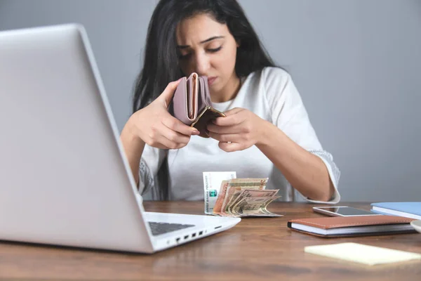 sad woman hand wallet with money on desk