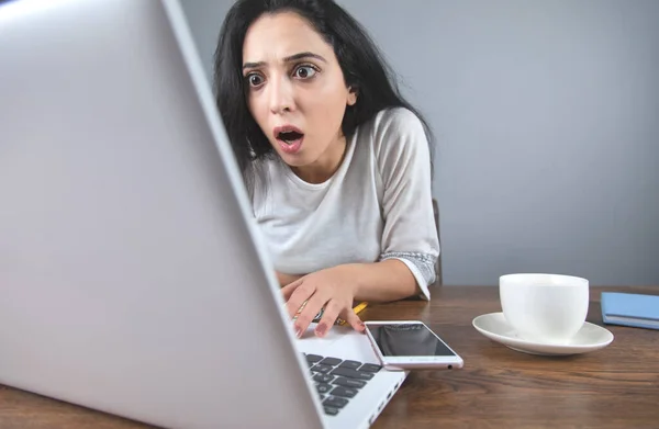 surprised woman hand computer on desk