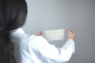 Kadın doktor el maskesi gri arka planda