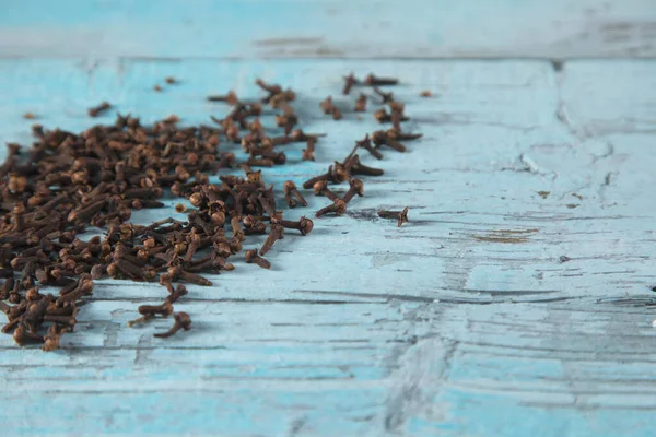 cloves on the blue vintage wooden table background