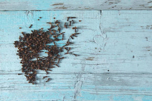 cloves on the blue vintage wooden table background