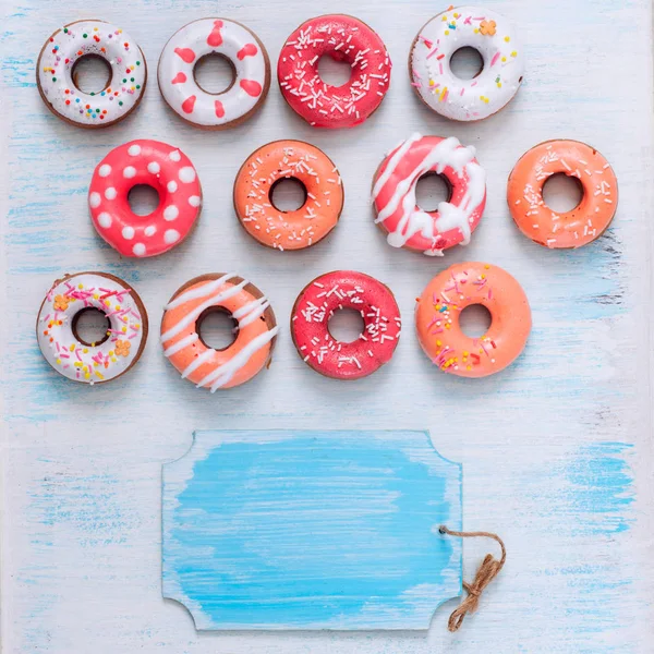 Sweet Menu of Donuts on the white and blue vintage background and a board with twine labeling — Stock Photo, Image
