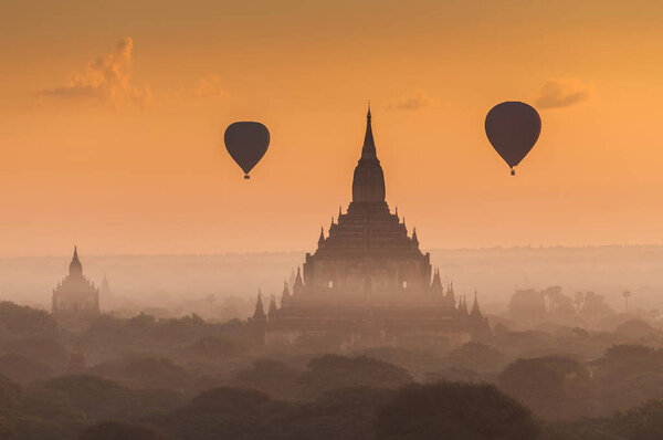 Hot air balloon over plain of Bagan in misty morning, Myanmar.