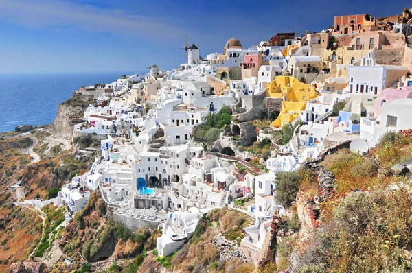 Viewing point of Santorini Caldera Oia white houses and windmills, Oia, Santorini Island, Greece. Stock Image