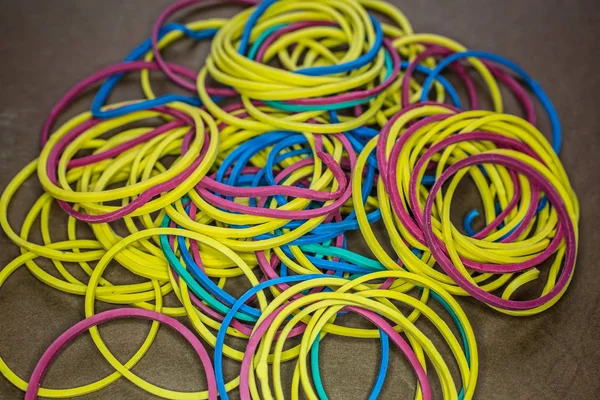 Rubber bands of different colors stretched into a ball