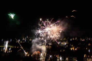 Gökyüzünde ışık izleri olan yeni yıl havai fişekleri.