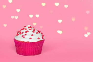 pink cupcake on pink background with bokeh