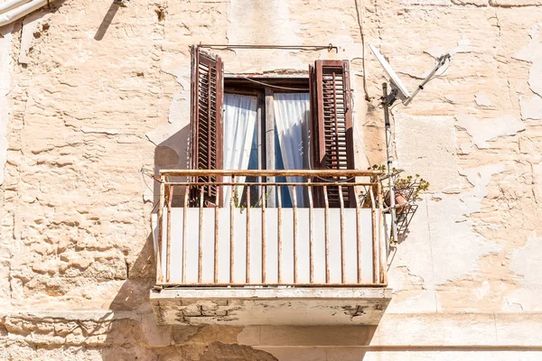 Old balcony with old wooden shutters