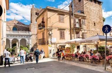 People enjoying a street bar in the historic center of Monreale, Sicily clipart