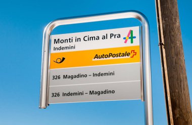 Alpe di Neggia, Ticino, Switzerland - Marc 7, 2014: PostBus Stop Sign, Monti in Cima al Par Indemini.