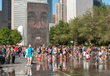 Chicago, Illinois, ABD - 15 Ağustos 2014: Chicago Downtown 'da sıcak bir yaz gününde Millennium Park' taki popüler Crown Fountain 'ın tadını çıkaran ziyaretçiler.