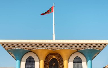 Muscat, Oman - February 10, 2020: The national flag of Oman on the Al Alam Palace, located in Old Muscat in Sultanate of Oman.