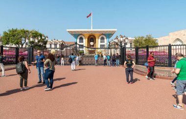 Muscat, Oman - February 10, 2020: Tourists visiting the Al Alam Palace, one of six sultanic residences, located in Old Muscat in Sultanate of Oman.