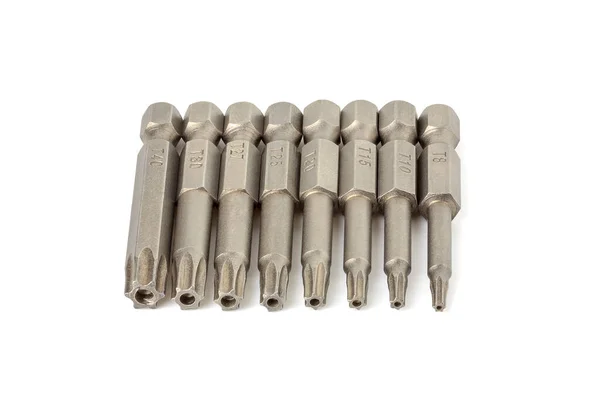 Set of various hexagonal star bits for screwdriver on a white background close-up. Screwdriver head nozzles isolate on white background. Hexagon screwdriver bits — Stock Photo, Image