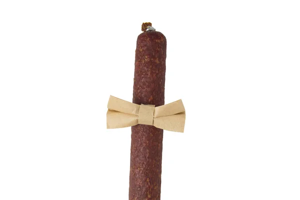 Portion of dry smoked sausage with bow-tie isolated on white background. Sausage dressed with a bow tie — Stock Photo, Image