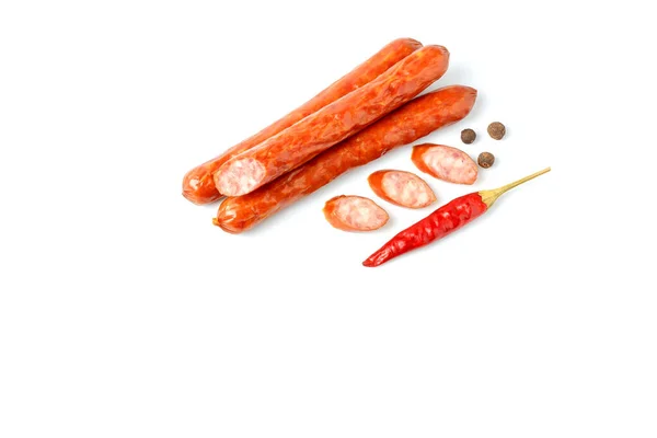 Соковиті свинячі ковбаски зі спеціями та червоним перцем чилі, вид зверху на білому тлі, місце для тексту Стокова Картинка
