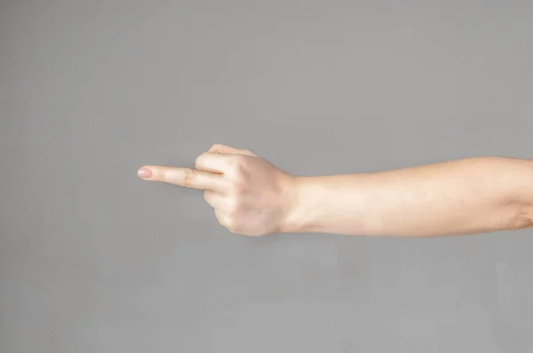Kobieta ręka pokazuje środkowy palec na białym odizolowanym tle — Zdjęcie stockowe