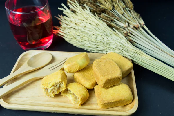 Pineapple shortcake or Pineapple pastry pie cake with pineapple jam on wooden tray. Sweet traditional Taiwanese pastry containing butter. fruit. dessert.