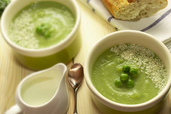 Vegetarian smoothie soup with green vegetables. Proper and healthy nutrition.Green puree soup with broccoli, zucchini, spinach, peas and vegetable milk. Vegan soup.