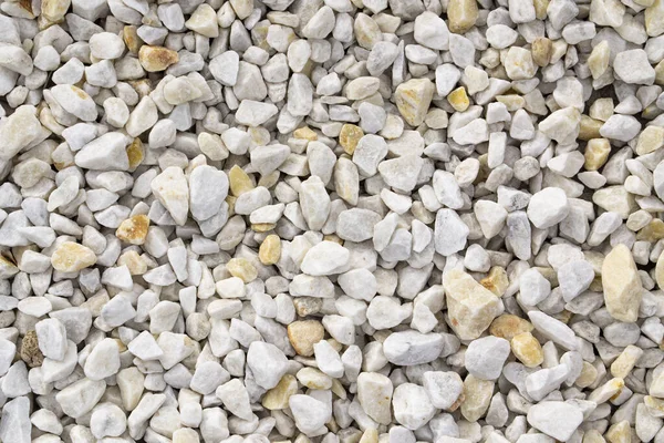 Road gravel, crushed stone. Gravel texture. Crack stones at a construction site. Seamless texture of white stones or gravel