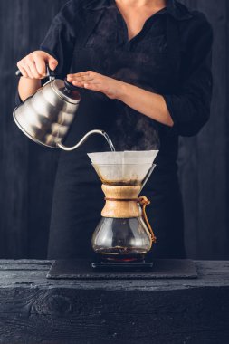 Professional barista preparing coffee alternative method clipart