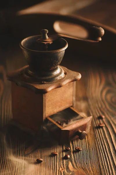 Koffiemolen en zak van gebrande koffie op houten tafel. — Stockfoto