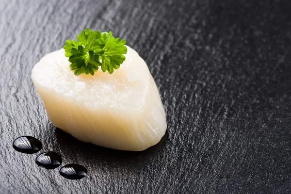 Scallop on black stone plate — Stock Photo, Image