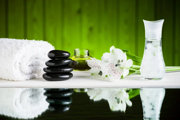 Zen basalt stones and spa on the wooden table — Stock Photo, Image