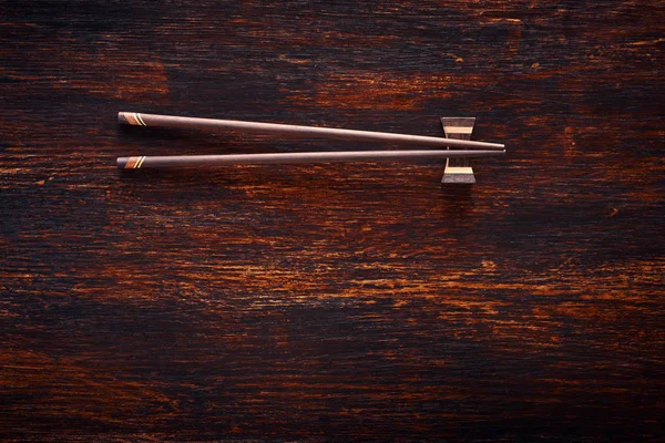 Japanese chopsticks on brown wooden table — Stock Photo, Image