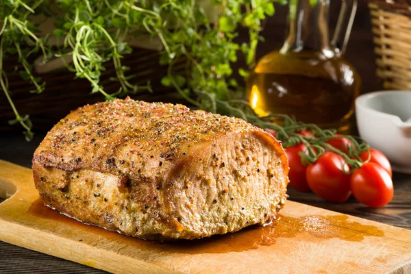 Roasted pork loin on the wooden table — Stock Photo, Image