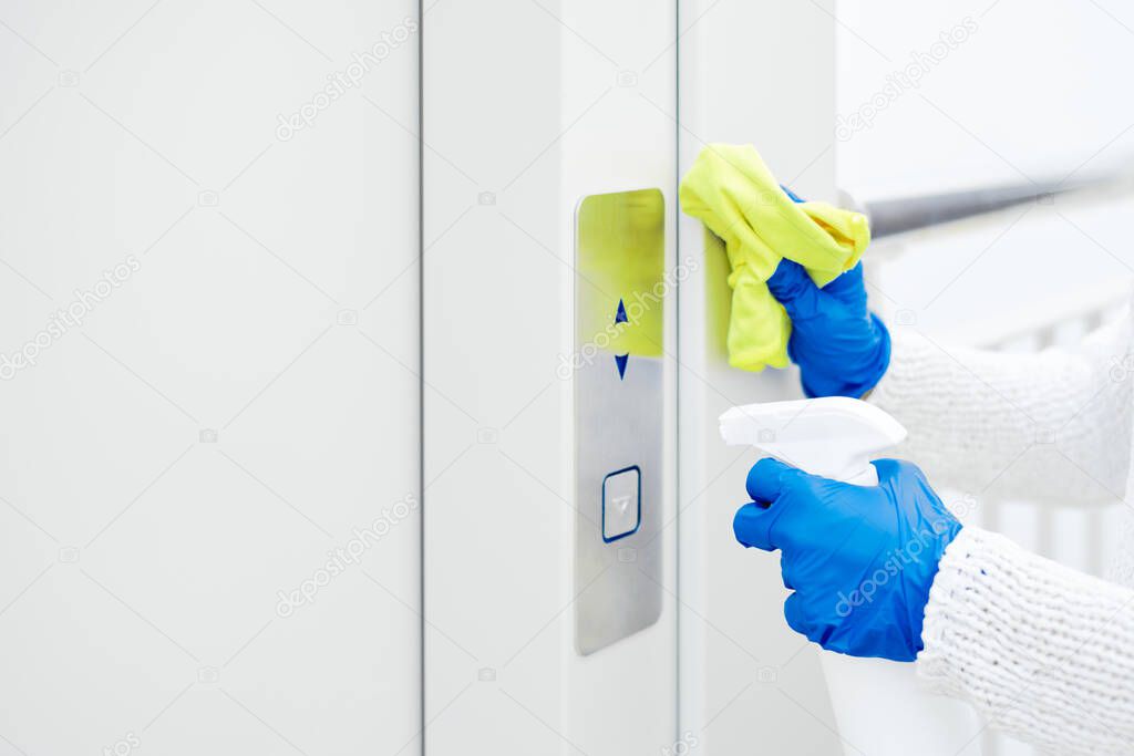 Close up hand of woman disinfecting lift push