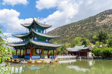 Landscape view of the Black Dragon Pool, it is a famous pond in the scenic Jade Spring Park located at the foot of Elephant Hill,Lijiang China. clipart