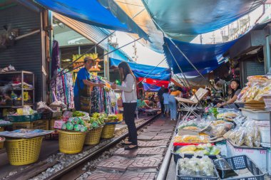Turistler Maeklong Demiryolu Pazarı boyunca gezip alışveriş yapabiliyorlar.