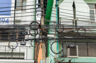 Bangkok,Thailand - October 29,2019 : Messy electric wiring on the pole in Bangkok,Thailand.