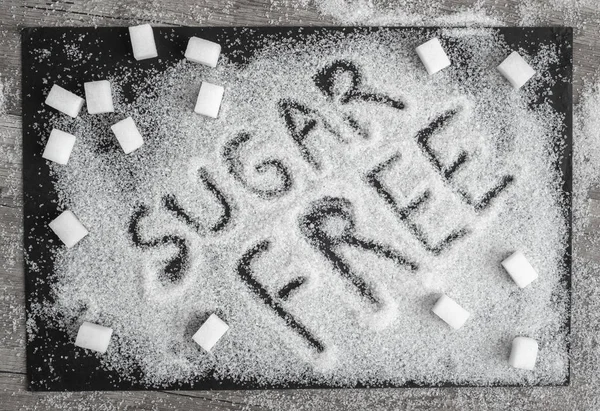 Sugar on a black background top view with text \