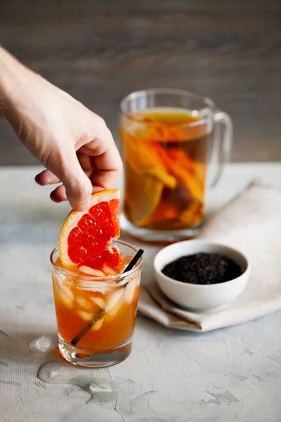 Refreshing healthy cocktail of fermented raw kombucha tea with a slice of grapefruit and ices.Kombucha mushroom tea is a natural fermented drink originally from China.