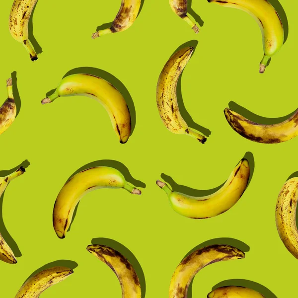 Colorful creative seamless fruit pattern set of organic ugly fruit bananas on green color background in pop-art style