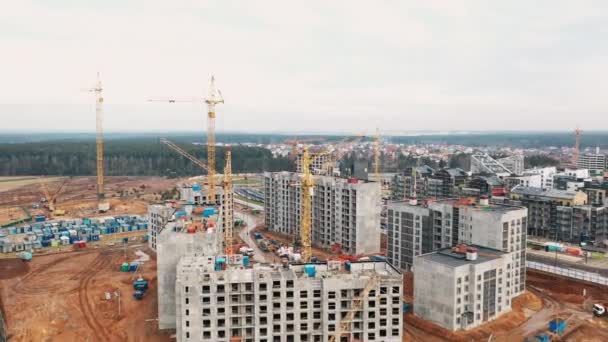 Modern büyük şehrin arka planına karşı güçlü vinçler inşa etmek — Stok video