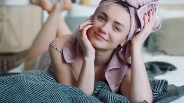 Beautiful girl cutely smiling in blue contact lenses and shiny earrings — Stock video