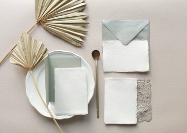 Blank white Wedding invitation cards mockups with dried palm leaf and craft envelope on textured table backgound. Elegant modern template for branding identity. Tropical design. Wedding stationery. Fl
