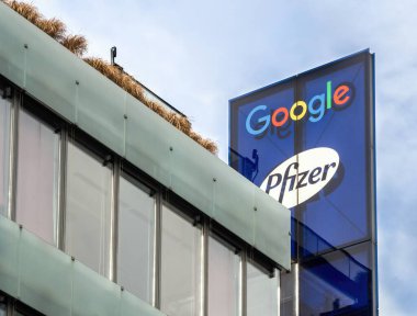 PRAGUE - FEBRUARY 26, 2020: Logo of Google and Pfizer on office building on Stroupeznikeho street in Smichov quarter. clipart