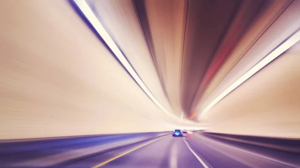 Vintage toned motion blurred car driving in tunnel. — Stock Photo, Image