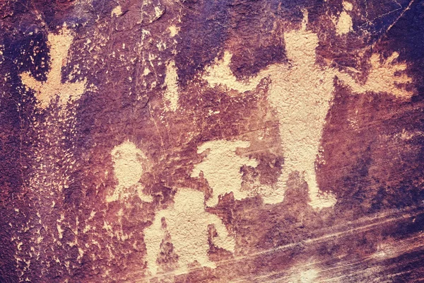 Color toned petroglyphs, ancient culture background. — Stock Photo, Image