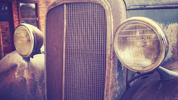 Color toned close up picture of an old rusty car headlamps. — Stock Photo, Image