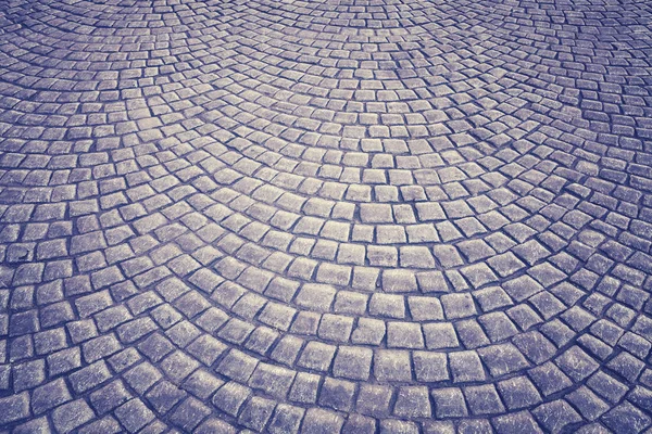 Vintage toned old cobblestone pavement background — Stock Photo, Image