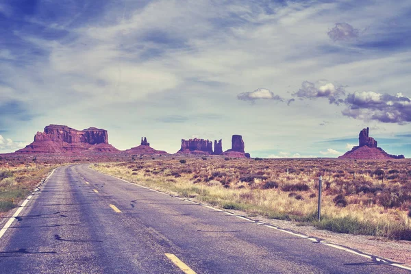 Color toned image of a road towards Monument Valley buttes. — Stock Photo, Image