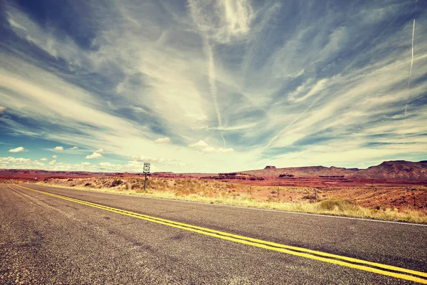 Vintage toned picture of a scenic desert road — Stock Photo, Image