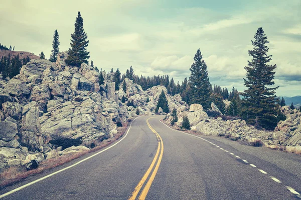 Retro toned scenic winding mountain road. — Stock Photo, Image