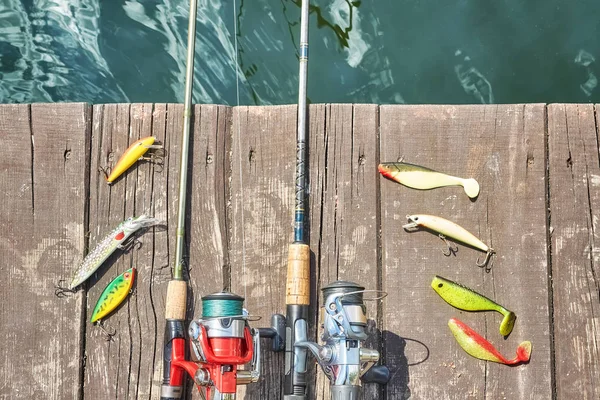 Due canne da pesca con mulinelli e esche filanti artificiali . — Foto Stock
