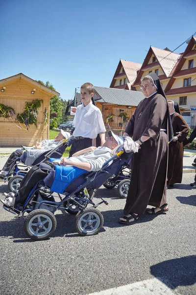Disabled men on wheelchairs during Corpus Christi procession. — Stock Photo, Image
